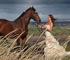 Woman in wedding dress with horse