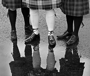 Reflection of wedding party in a puddle