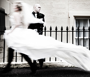 Bride rushing by standing groom