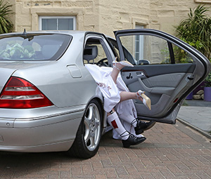 Bride and Groom posing in car